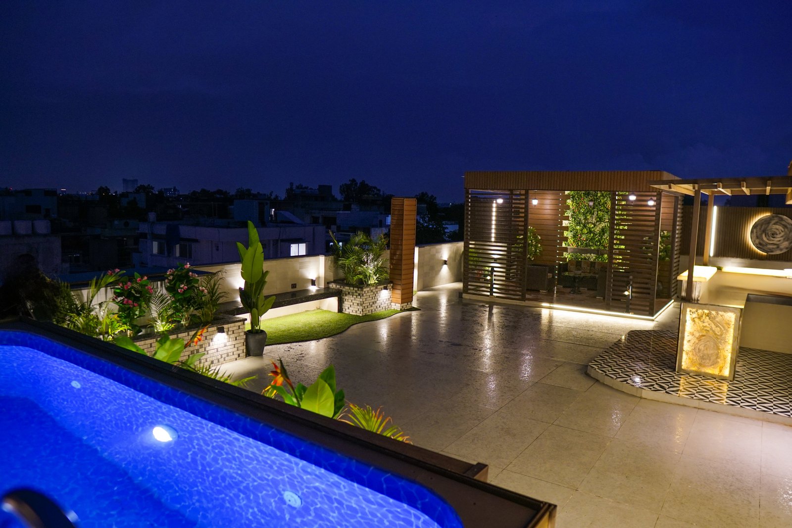 Punjabi Bagh rooftop — raised mosaic pool with warm cladding