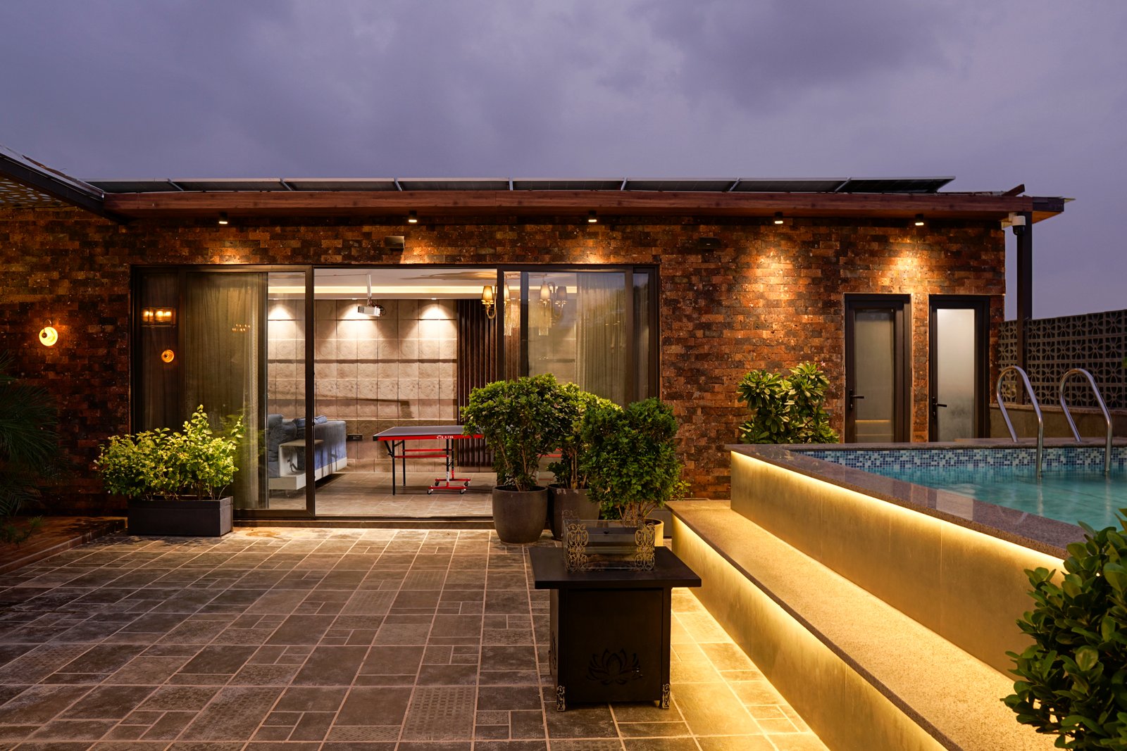 Rajouri Garden terrace — AC gazebo interior with marble and brass finishes